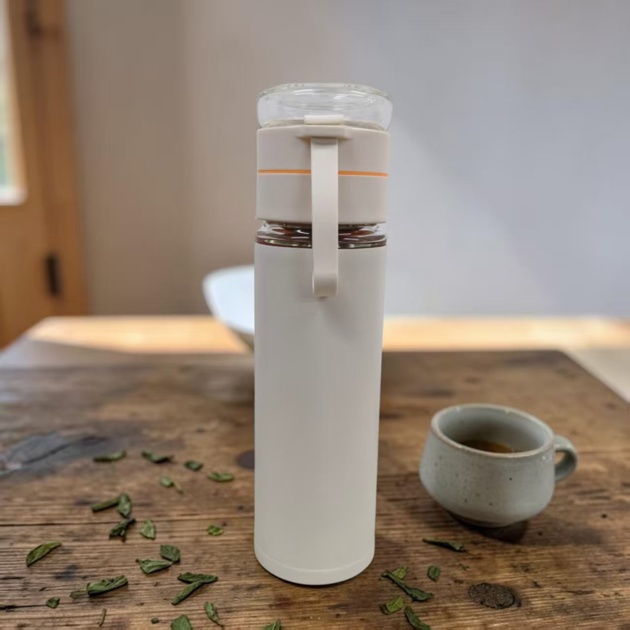 Diverse collection of custom printed double-wall glass tea infusers showcasing various Singapore corporate branding applications