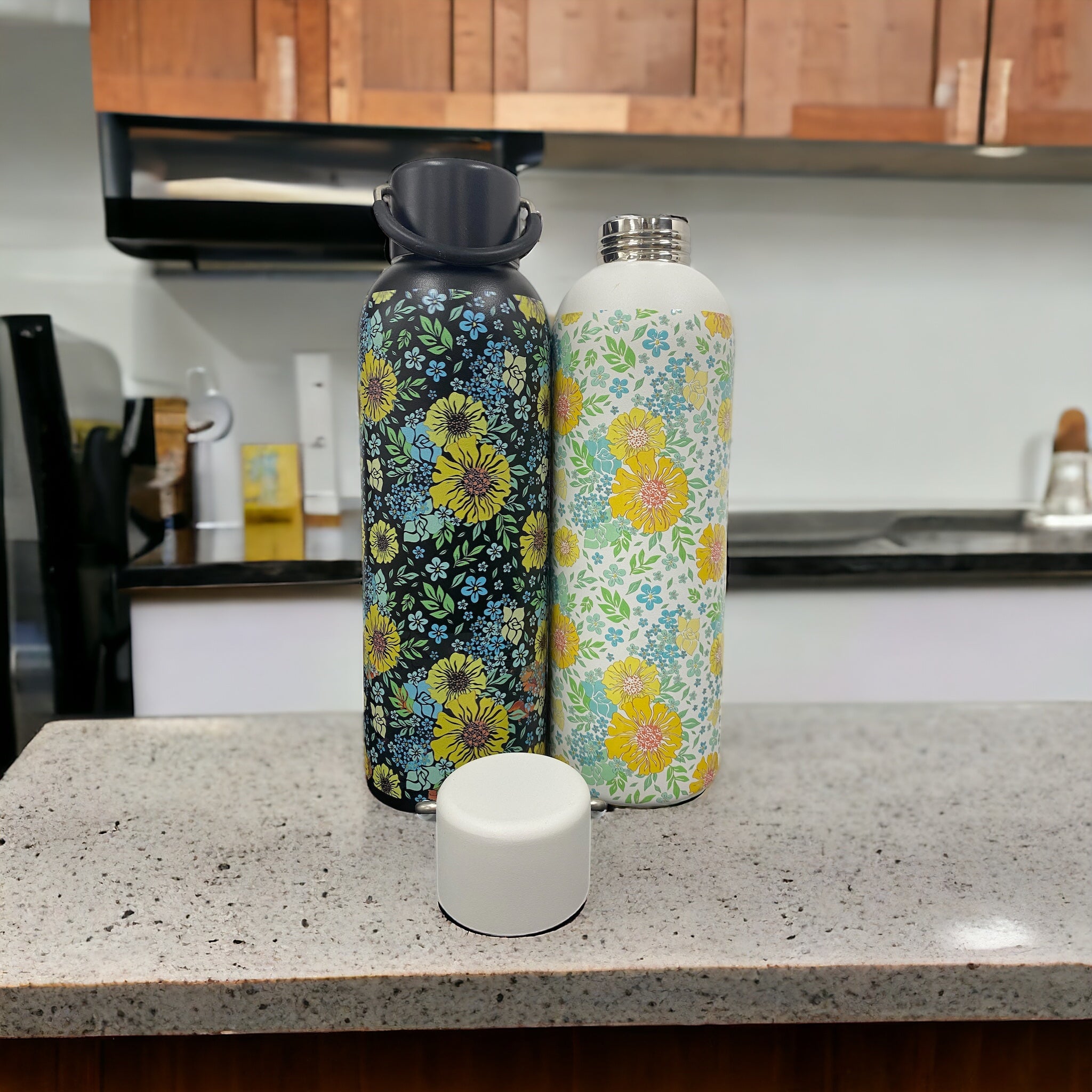 Multiple custom thermos flasks in various colors with corporate logos on modern office desk