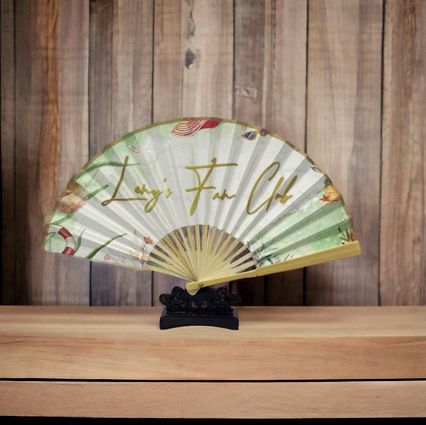Personalised bamboo fan at outdoor event showing corporate branding Singapore