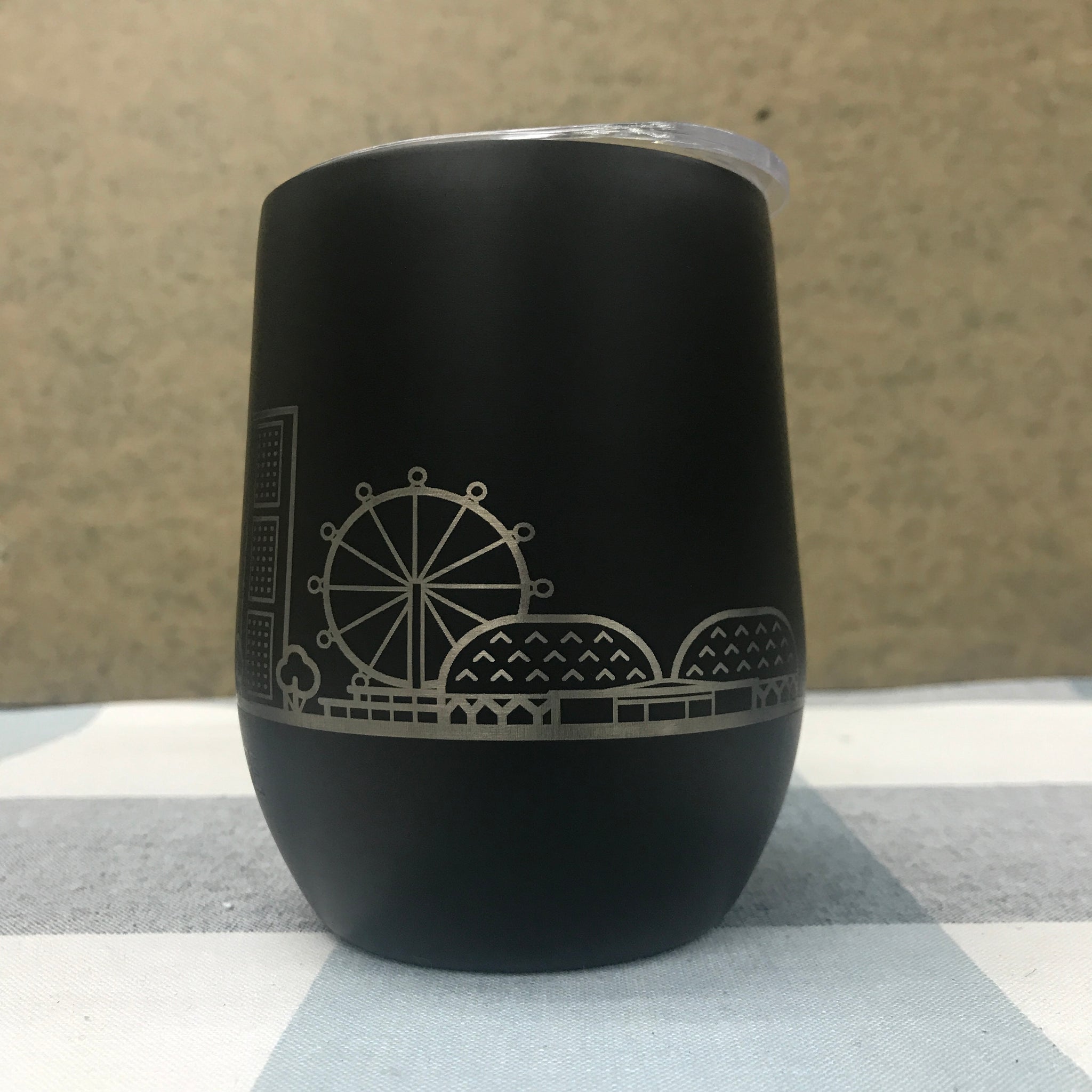 Custom tumbler with student backpack showing compact portable design for campus and office use