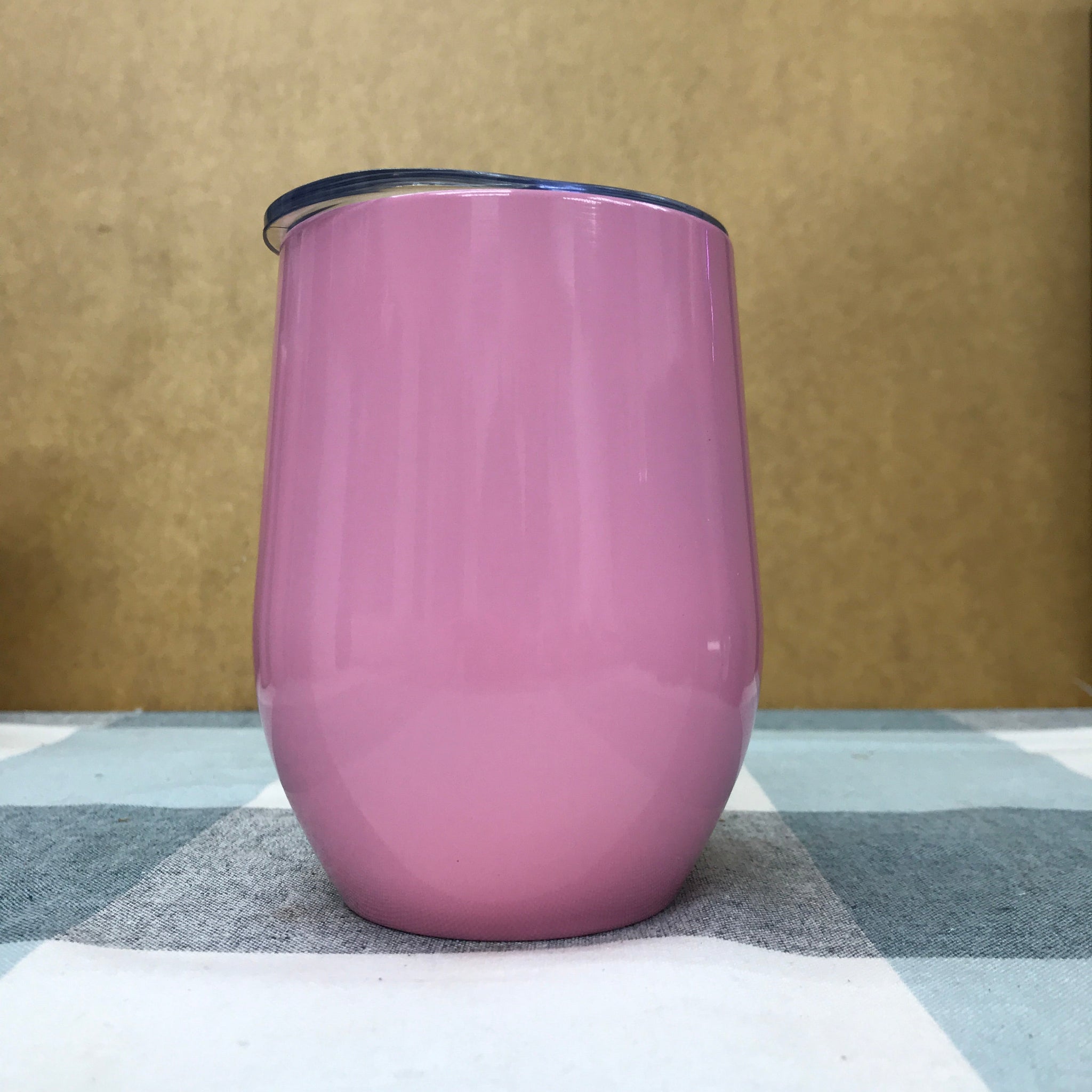 Multiple custom tumblers in various colors with corporate logos on modern office desk