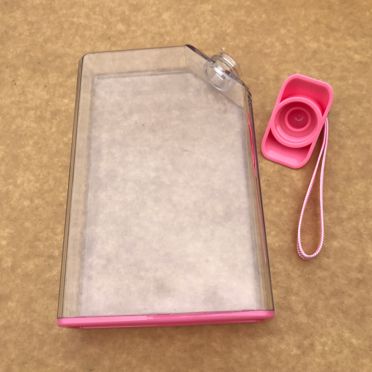 Multiple custom water bottles in various colors with corporate logos on conference table