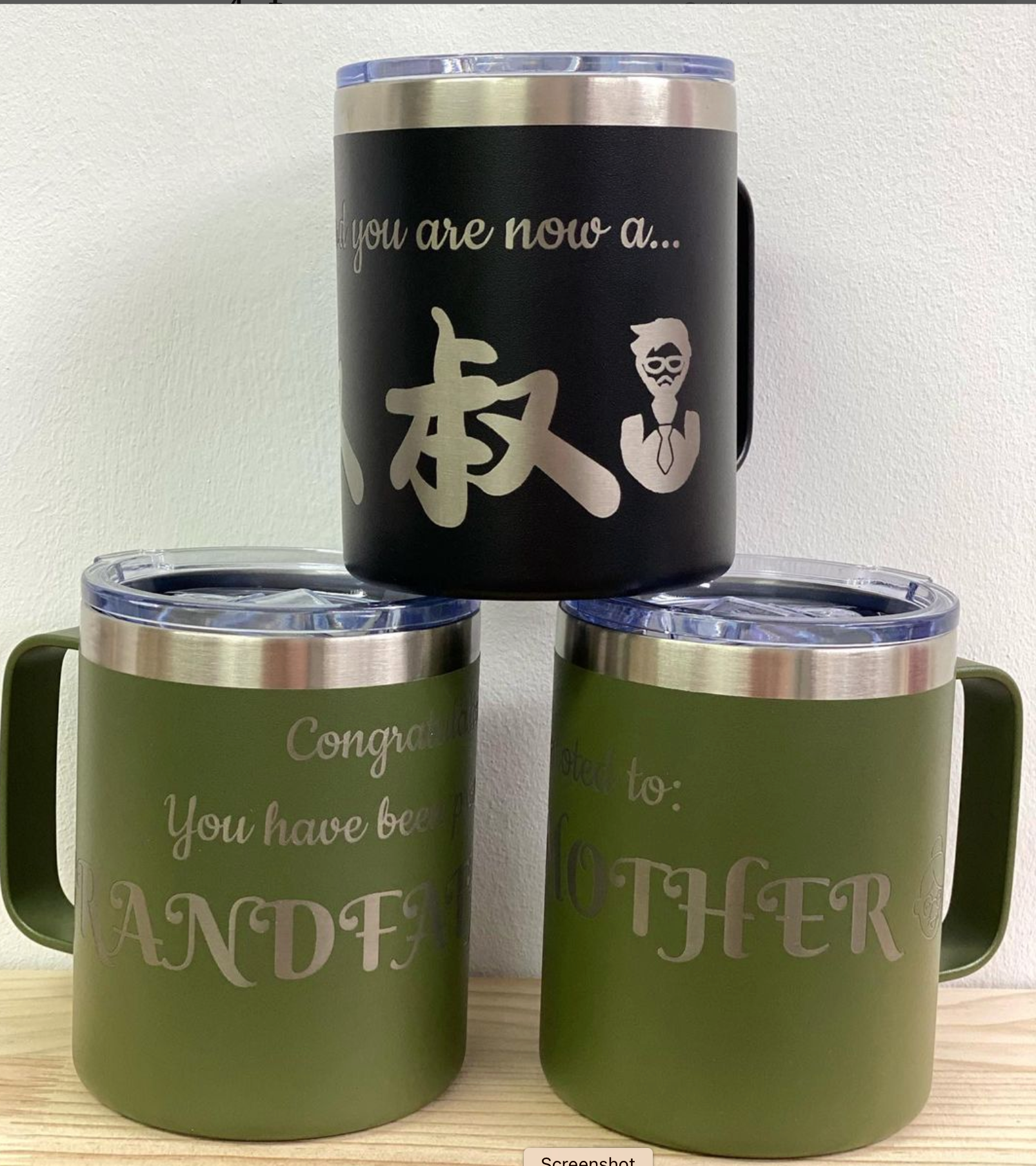 Multiple custom ceramic coffee mugs in various designs with corporate logos on modern office setting