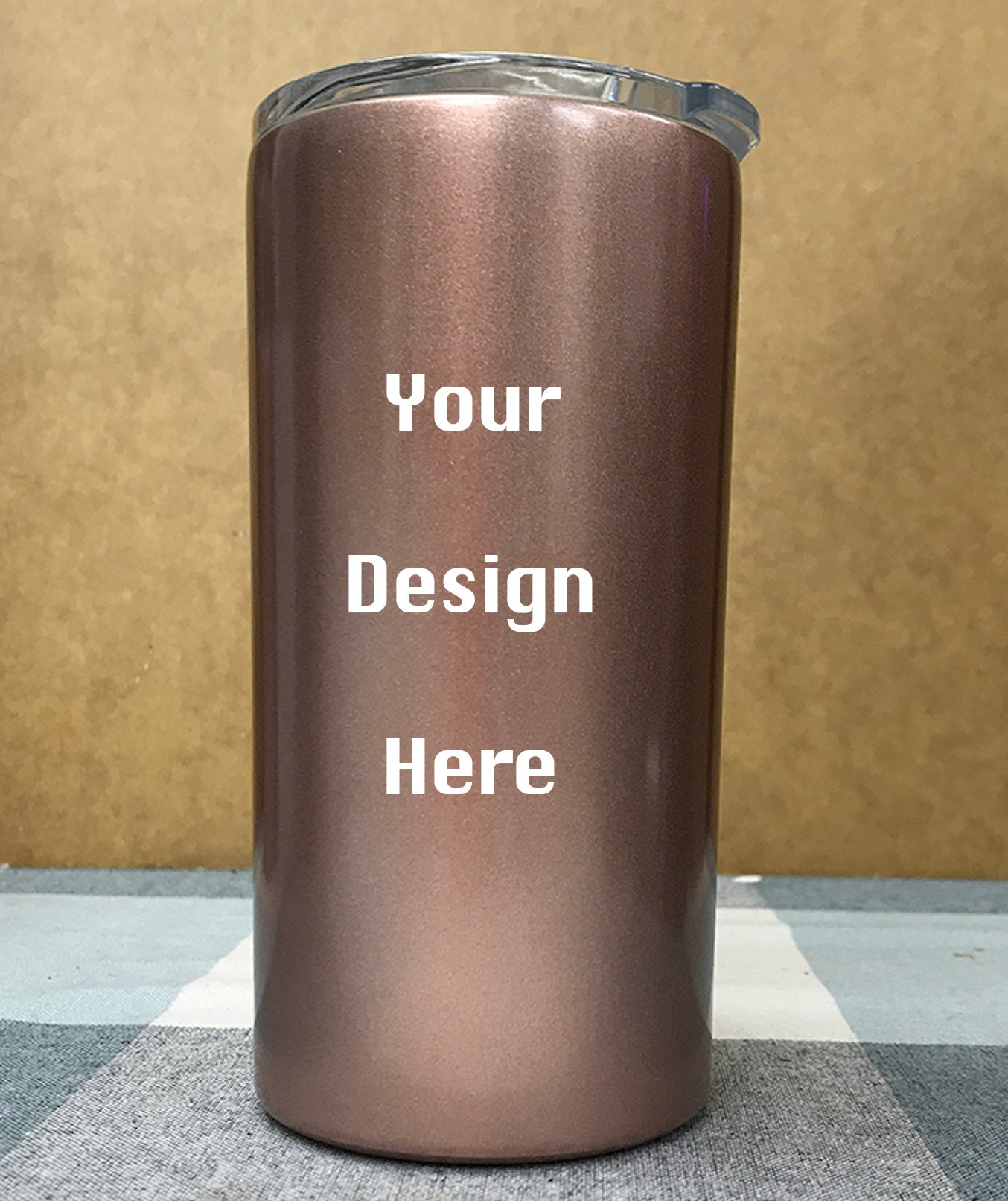Multiple custom tumblers in various colors with corporate logos on modern office desk with laptop